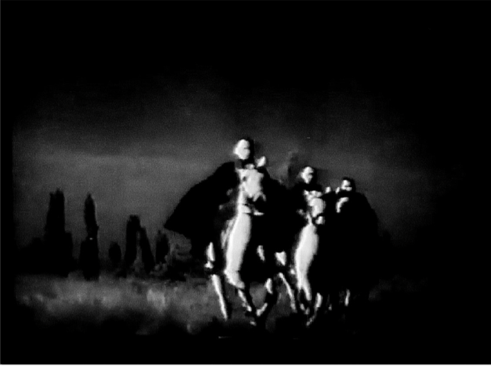 Night shot from Fährmann Maria: two cloaked riders on horseback move through a marsh past silhouetted trees.
