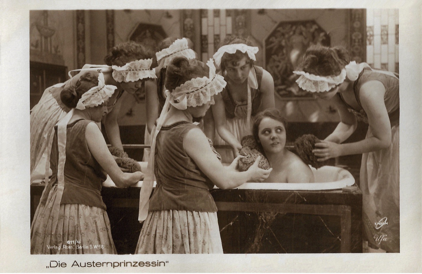 Vintage postcard for Die Austernprinzessin: Ossi Oswalda being bathed by a group of maids gathered around a tub.